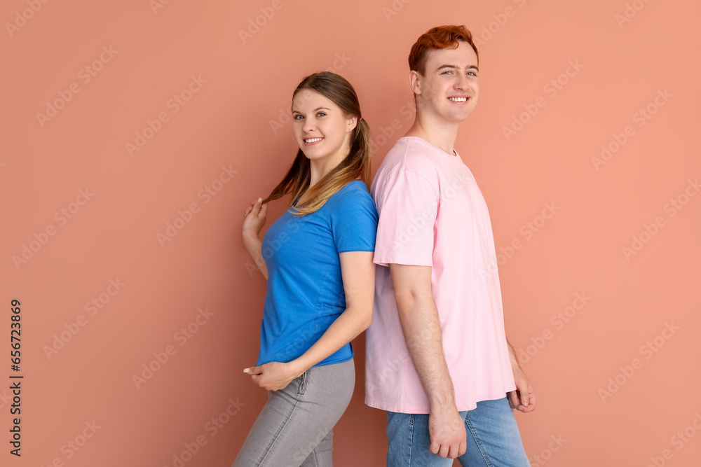 Young couple in t-shirts on beige background