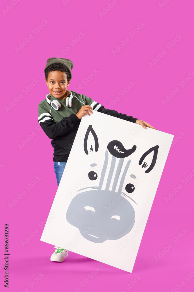 African-American little boy with picture on purple background