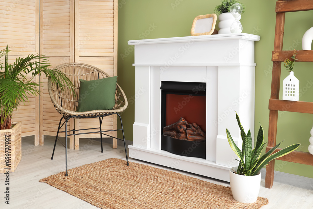 Interior of room with modern fireplace and houseplants