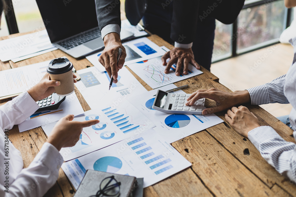 Business advisory meeting discussing analyzing company growth using business reports and financial charts. Brainstorming, analyzing strategies and planning investments.