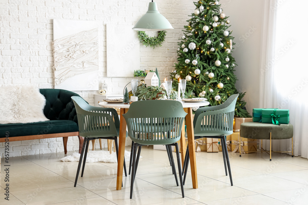 Festive table setting with Christmas decor in light room