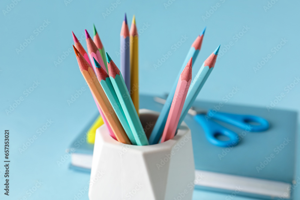 Holder with different pencils on color background, closeup