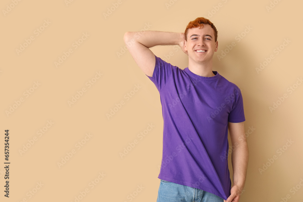 Young man in purple t-shirt on beige background