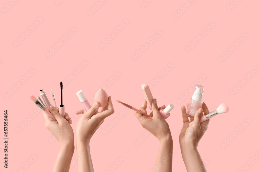 Women with cosmetic products on pink background