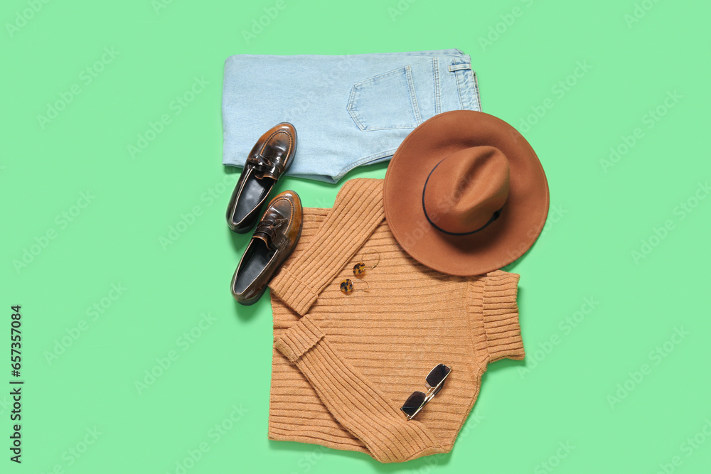 Composition with stylish female clothes, shoes and accessories on green background