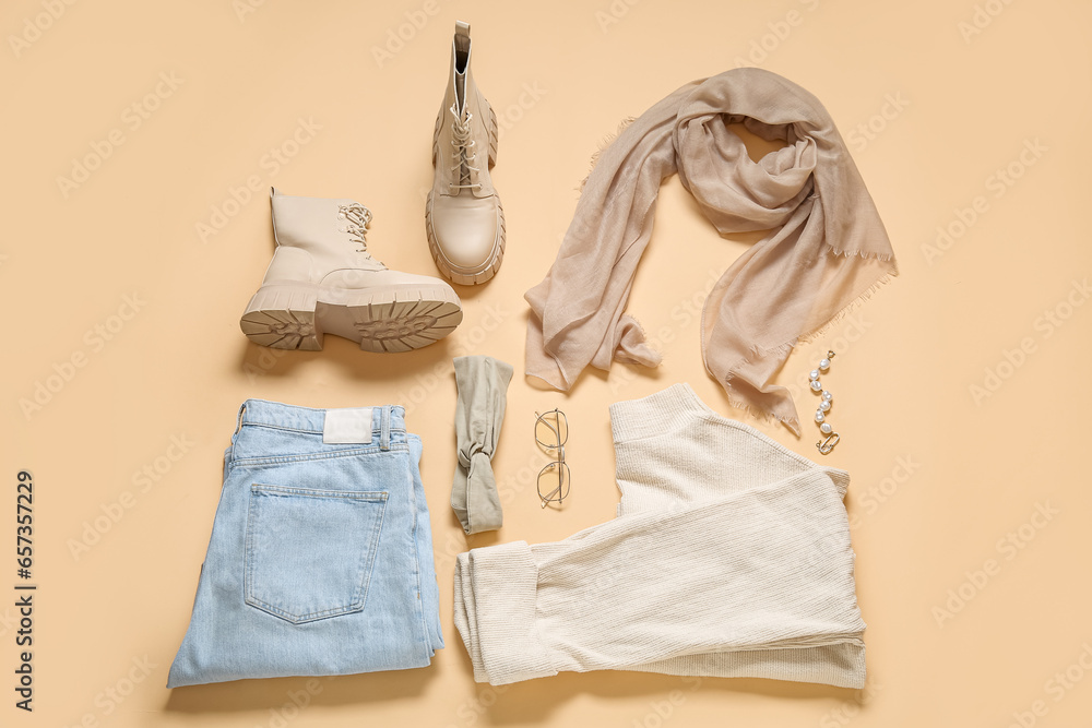 Composition with stylish female clothes, boots and accessories on color background