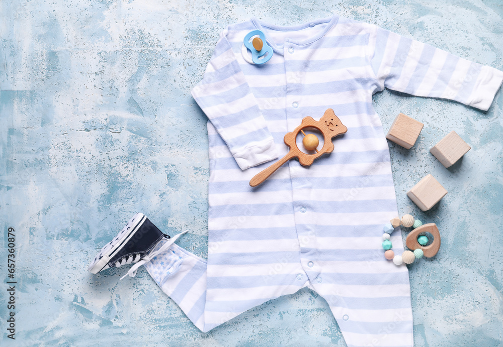 Composition with baby clothes, accessories and toys on color background