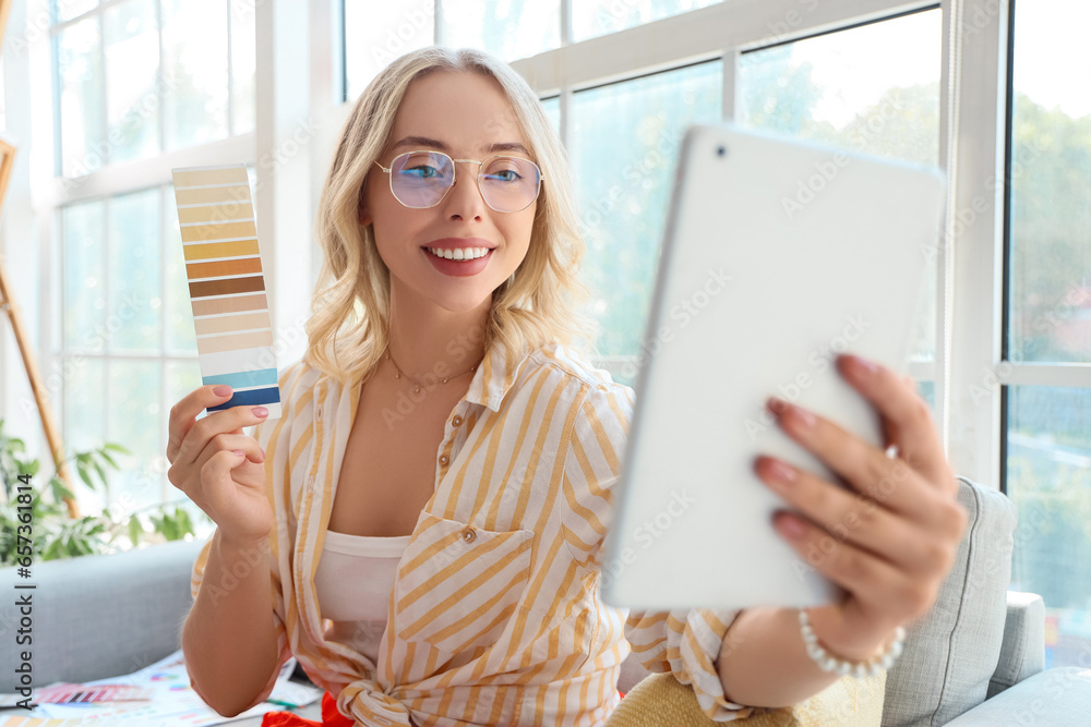 Female interior designer with color palette video chatting in office