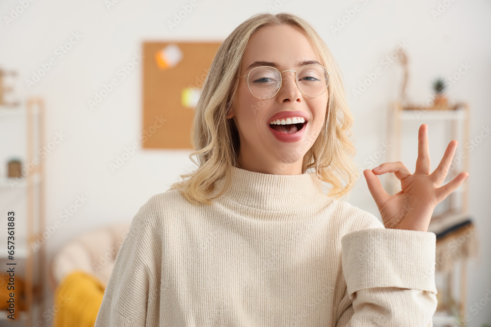 Female interior designer showing OK in office, closeup