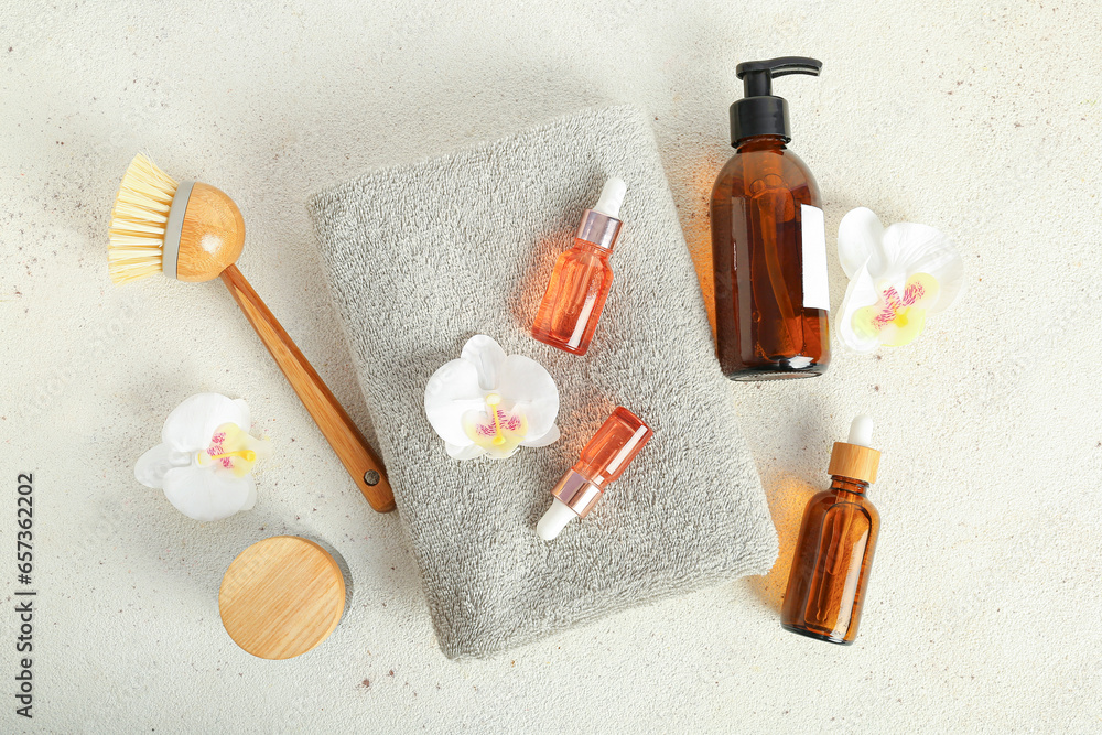 Composition with cosmetic products, bath supplies and orchid flowers on light background