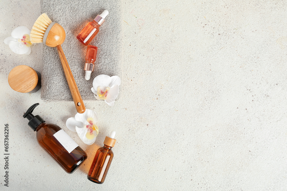 Composition with cosmetic products, bath supplies and orchid flowers on light background