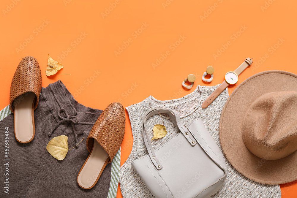 Composition with stylish female clothes, accessories and shoes on orange background