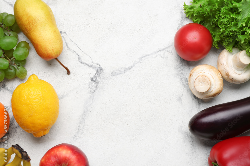 Frame made of fresh vegetables and fruits on white marble background. World Vegan Day concept