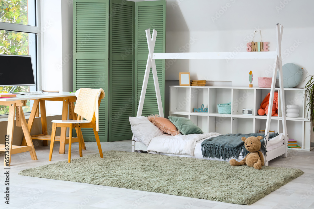 Interior of childrens room with bed and study table