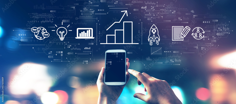 Business growth analysis with a smartphone in blurred city lights at night