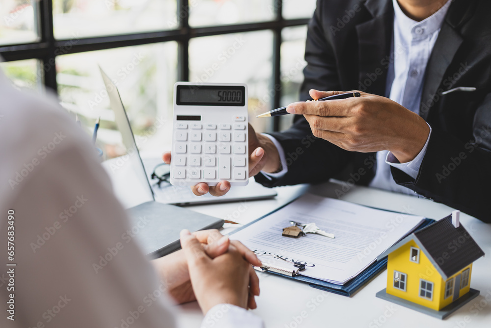 Businessman, real estate agent discussing the terms of the house purchase agreement contract document and letting the client sign legally, mortgage, rent, insurance.