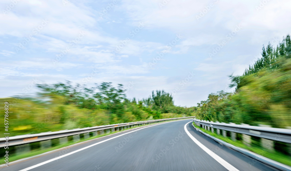 Empty curved road in motion blur