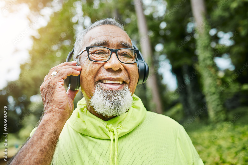 Mature, man and headphones on walk in nature for health, fitness and exercise in portrait. Senior, person and face in happiness for workout in park, woods and listen to podcast, music or streaming