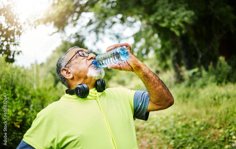 Senior man, fitness and drinking water in nature for hydration or natural sustainability after workout. Mature male person with mineral drink from exercise, training or cardio in recovery or break