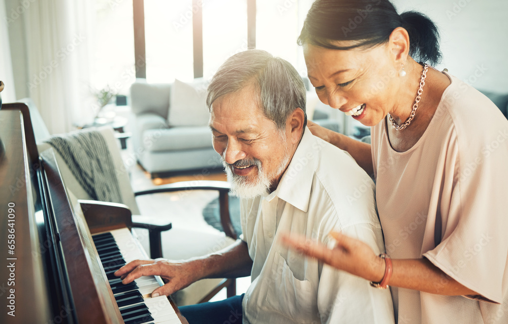 Senior couple playing piano for music in living room for bonding, entertainment or having fun. Happy, smile and elderly Asian man and woman in retirement enjoying keyboard instrument at modern home.