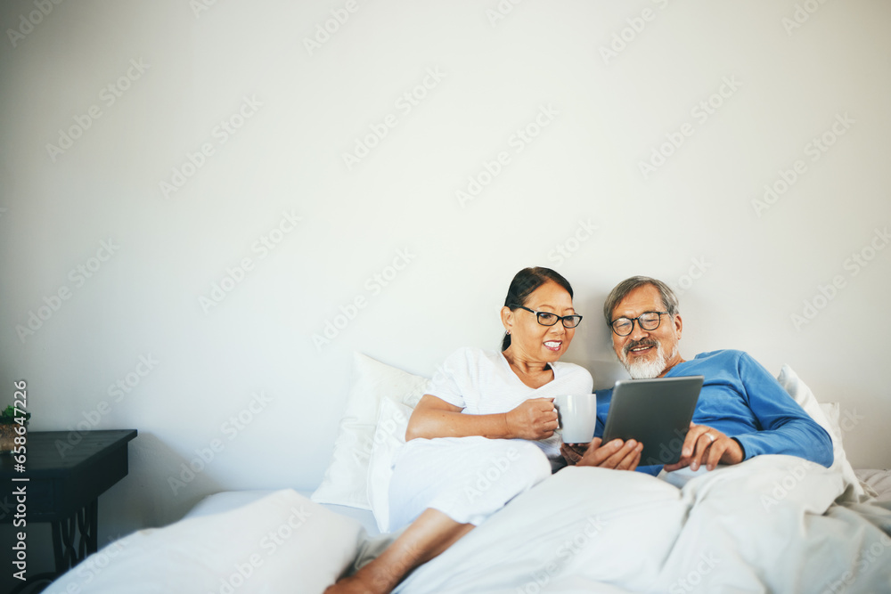 Tablet, senior or happy couple in bed on social media for communication on website or internet. People, bedroom or mature woman watching movie with an Asian man online streaming on technology at home