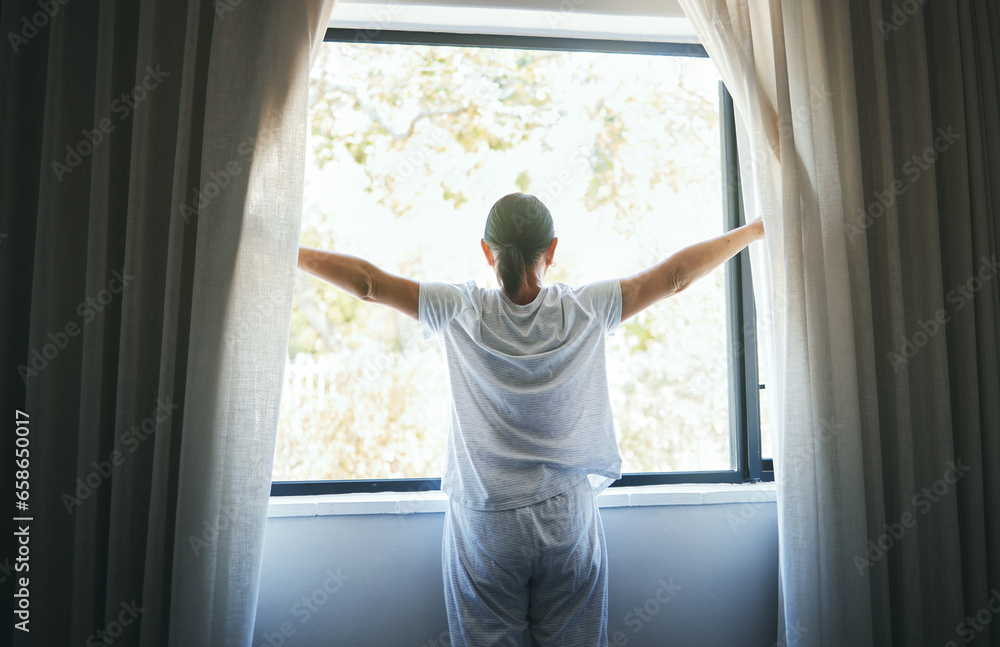 Open, curtains and back of woman at window for wake up, sunrise and good morning routine in bedroom at home. Awake, drapes and light of sunshine for inspiration, relaxing view or start bright new day