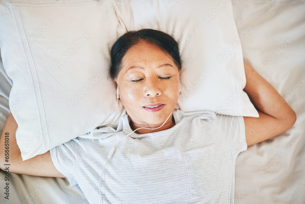 Bedroom face, music and relax woman sleeping, tired or nap for break, morning wellness or listening to audio podcast. Fatigue, radio sound and top view person cozy, dream and exhausted on home bed