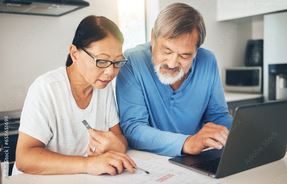 Couple, computer and home documents for finance, loan payment and mortgage planning, bills and invoice in kitchen. Mature woman and man with asset management, life insurance and paperwork on laptop