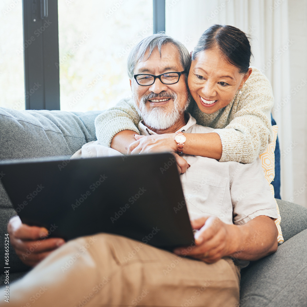 Laptop, smile and senior couple on a sofa watching movie, show or film together in living room. Happy, technology and elderly man and woman in retirement streaming a video on computer at modern home.