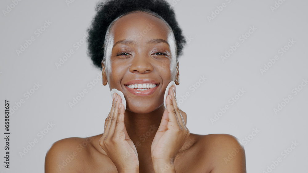 Face, model and hands with cotton for beauty, facial and cosmetic with happiness in studio background. Black woman, healthy skin and dermatology with self care, spa treatment and aesthetic portrait