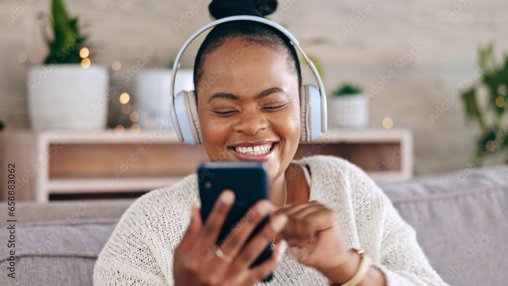 Black woman, headphones for music and smartphone, relax on couch at home and audio streaming with smile. Happiness, mobile app and using phone for radio or podcast, scroll with technology in lounge