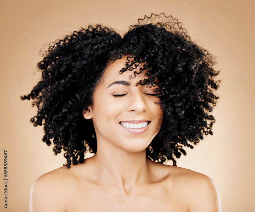 Woman, curly or wind in afro hair for fun on studio background in healthy hairstyle growth, texture or frizz treatment success. African beauty model, shake or change by shampoo transformation results