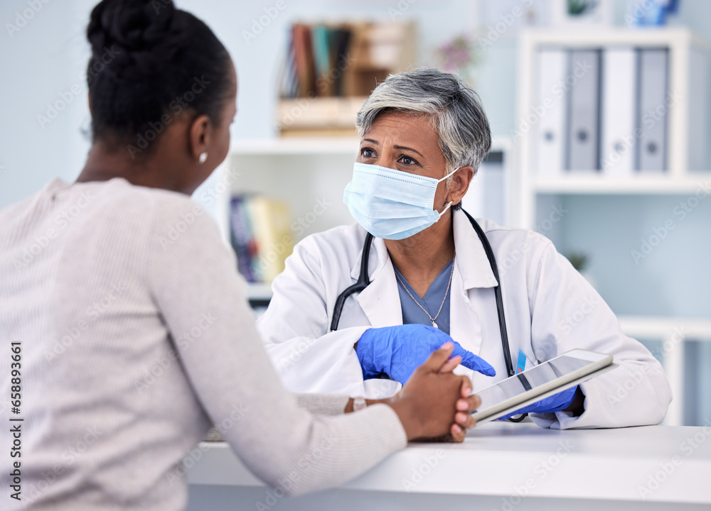 Senior woman, doctor and tablet with patient in consultation, checkup or diagnosis with mask at hospital. Mature female person, medical nurse or surgeon consulting customer with technology at clinic