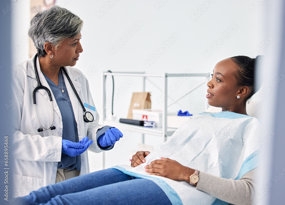 Dental, consultation and dentist with woman in a clinic for oral health or teeth examination. Checkup, discussion and senior female medical worker talking to African patient in a medicare hospital.