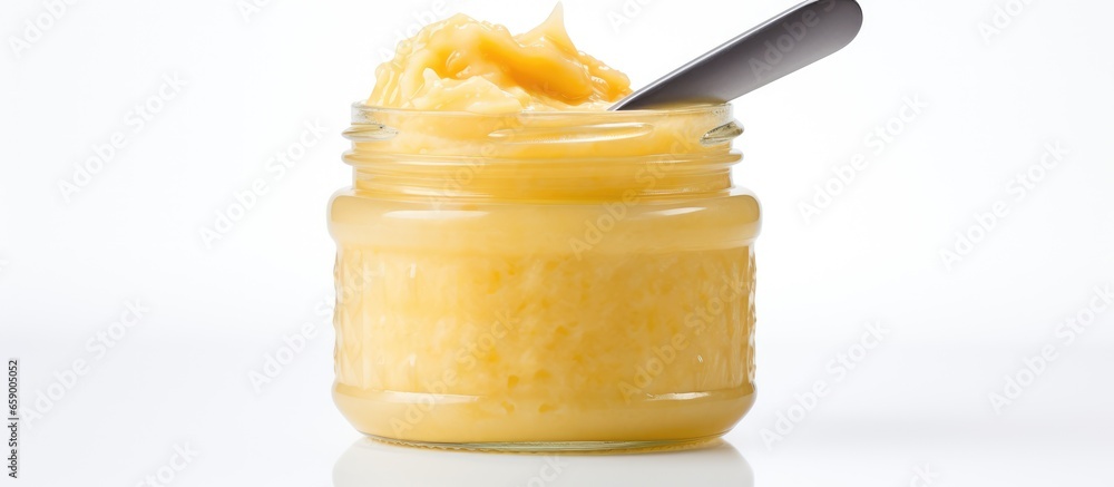 Baby pureed in jar on white background using a spoon