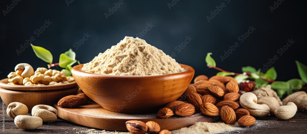 Various nut flours almond hazelnut cashew with keto baking essentials against dark backdrop Gluten free theme