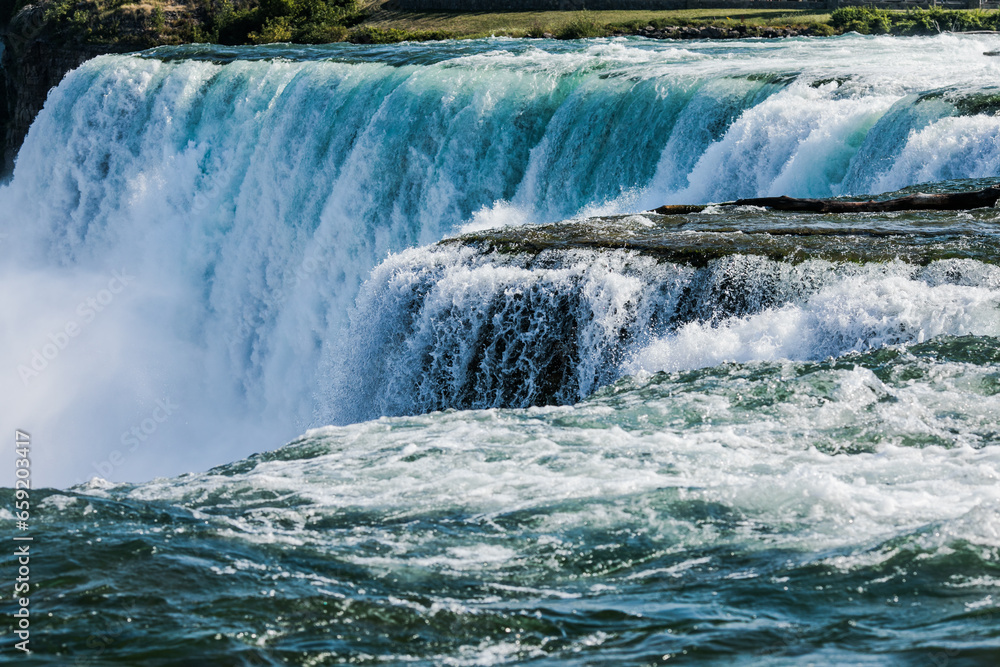 Panoramic aerial view of American  side view of Niagara Falls, American Falls and Rainbow International Bridge in a sunny day in Niagara Falls, USA