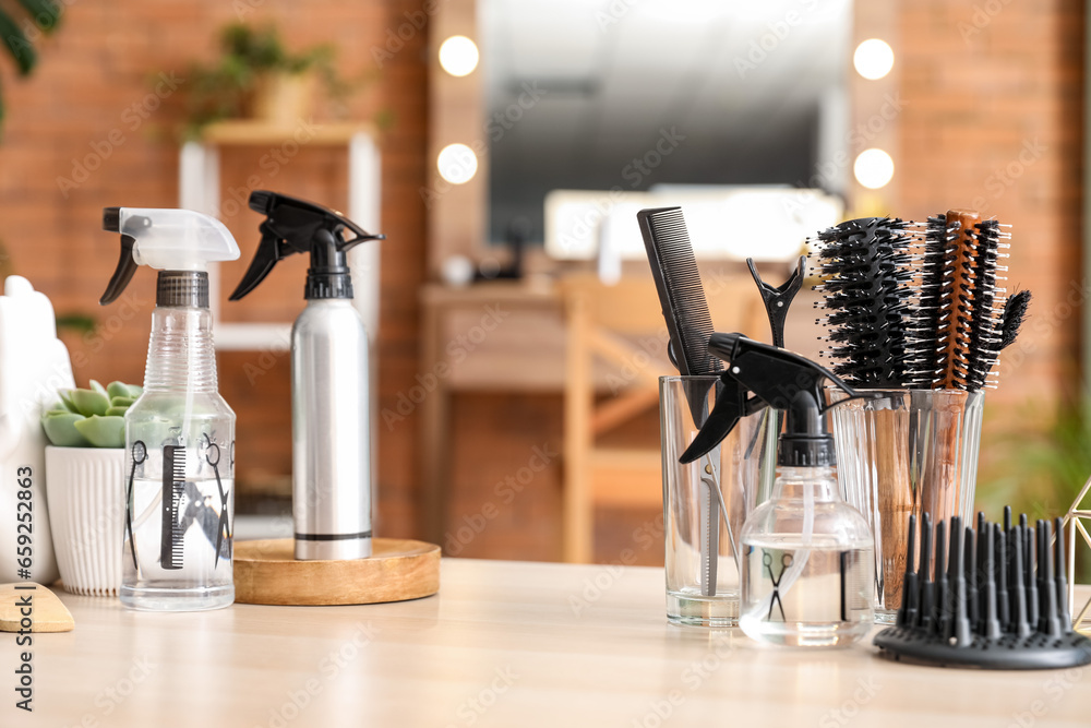 Different hairdressing tools on table in beauty salon