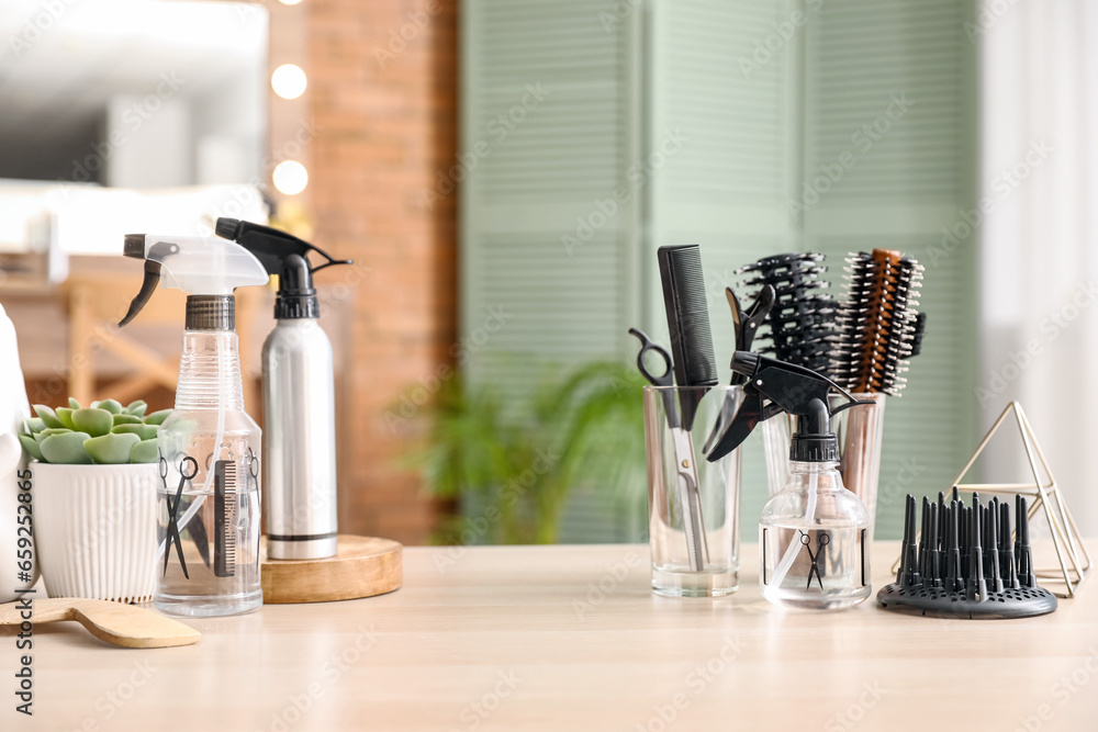 Different hairdressing tools on table in beauty salon