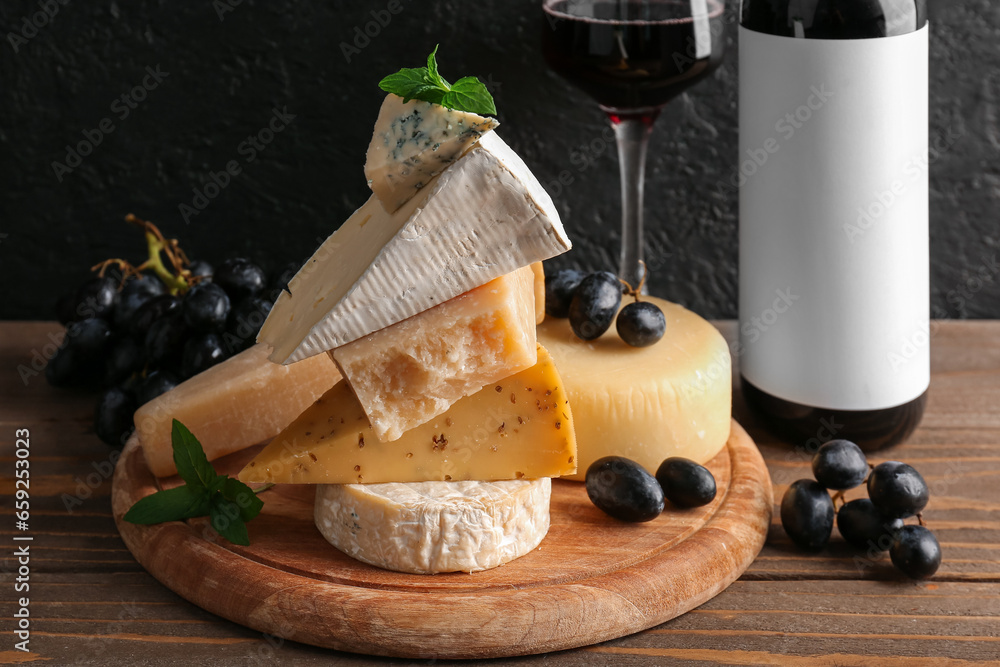 Wooden board with different types of tasty cheese on table