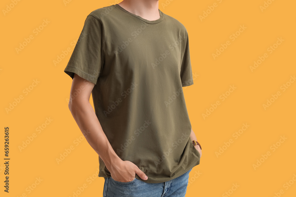 Man in stylish t-shirt on orange background