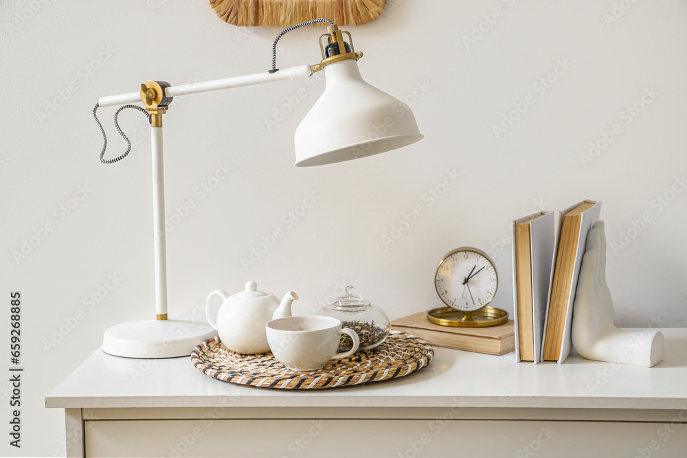 Tea set on shelf in room