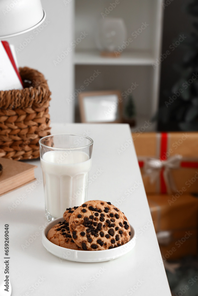 Christmas cookies with milk on table in living room, closeup