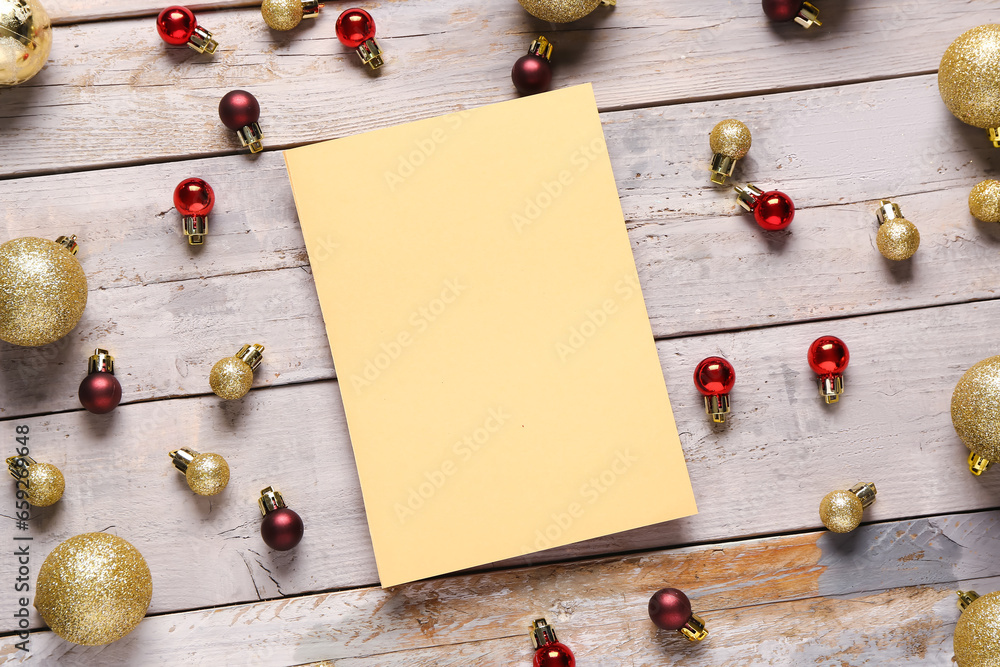 Beautiful composition with blank card and Christmas balls on grey wooden background