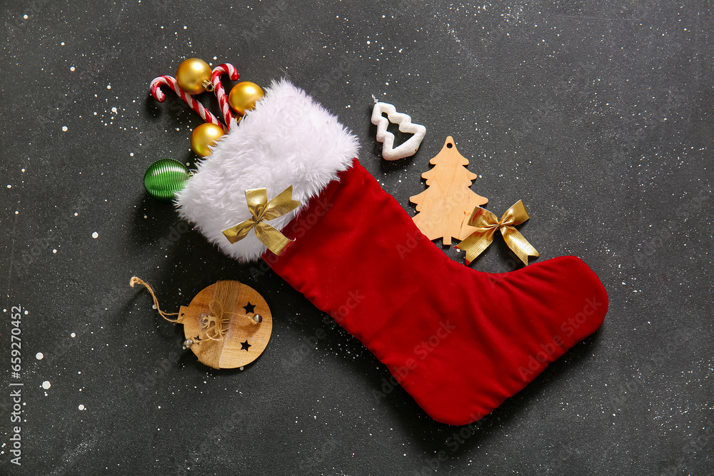 Christmas sock with beautiful decorations on black background