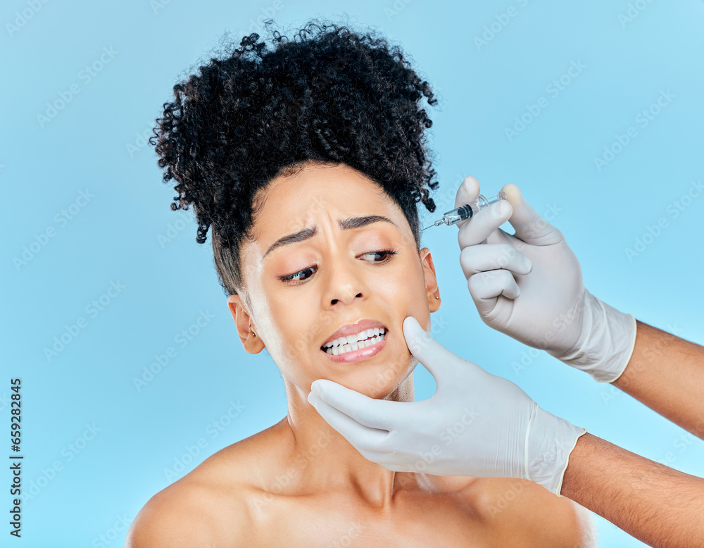 Filler, fear and woman with hands on face in studio for collagen skincare injection or implant. Model with stress, anxiety and syringe for beauty, dermatology or cosmetic process on blue background.