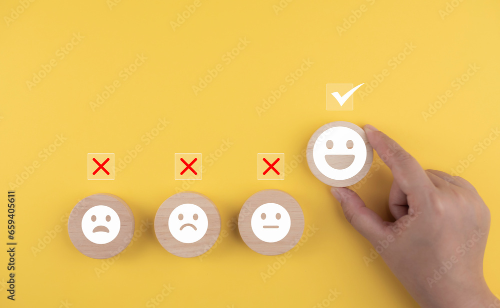 Customer satisfaction emoticon vote, Marketing survey, Hands choose a happy icon to smile face for the medical care, mental health positive thinking or satisfaction feedback from user experience.