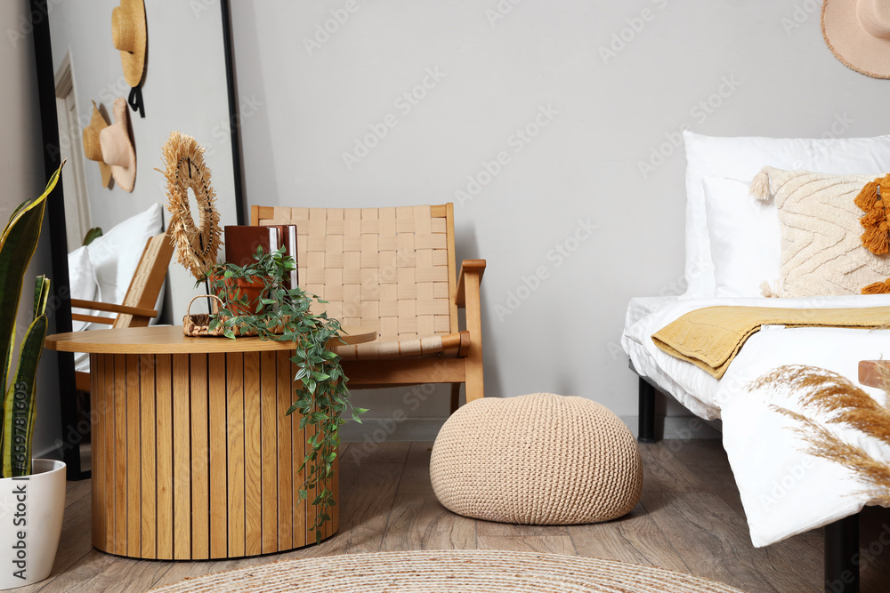 Interior of bedroom with coffee table and armchair