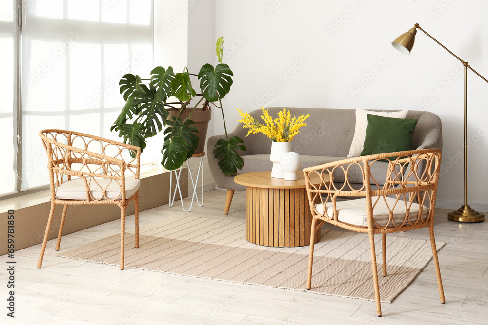 Interior of bright living room with armchairs, sofa and coffee table