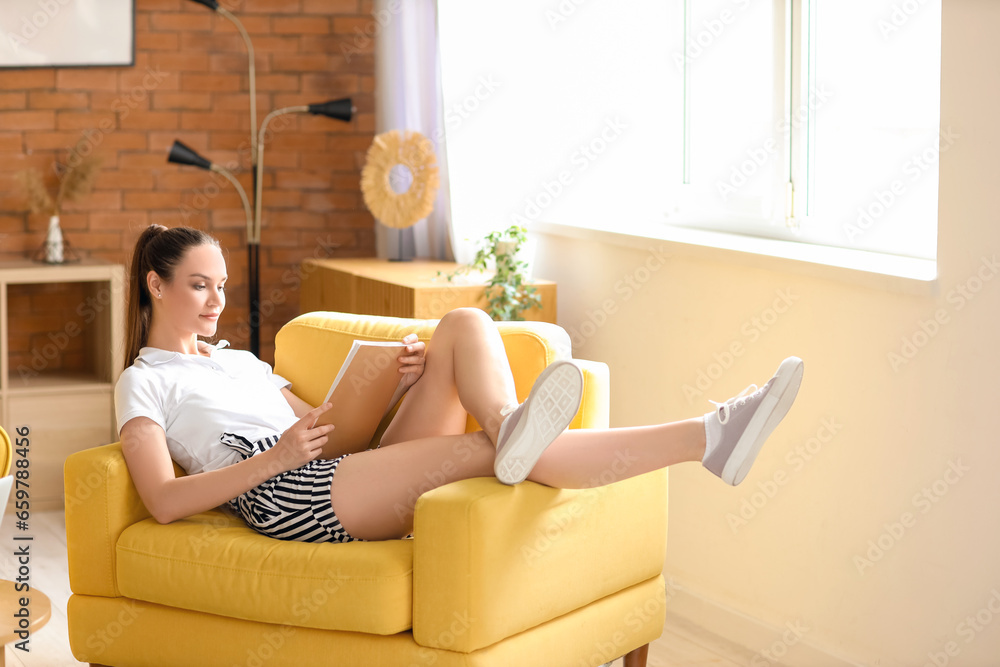 Young woman reading magazine on her day off at home